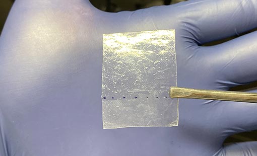 A picture of a special piece of clear tape developed by NREL that can absorb almost all lead in a perovskite cell.