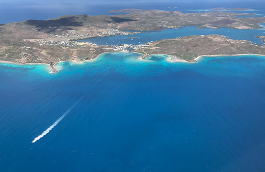 Aerial photo of a body of water and island.