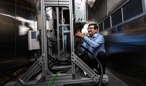 Researcher working on the residential battery test bed in the Energy Systems Integration Facility.