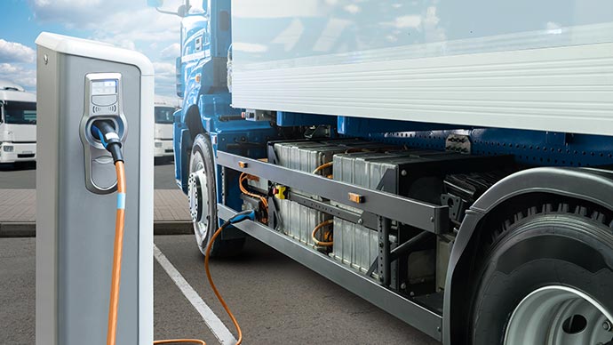 Electric truck plugged into charging station 