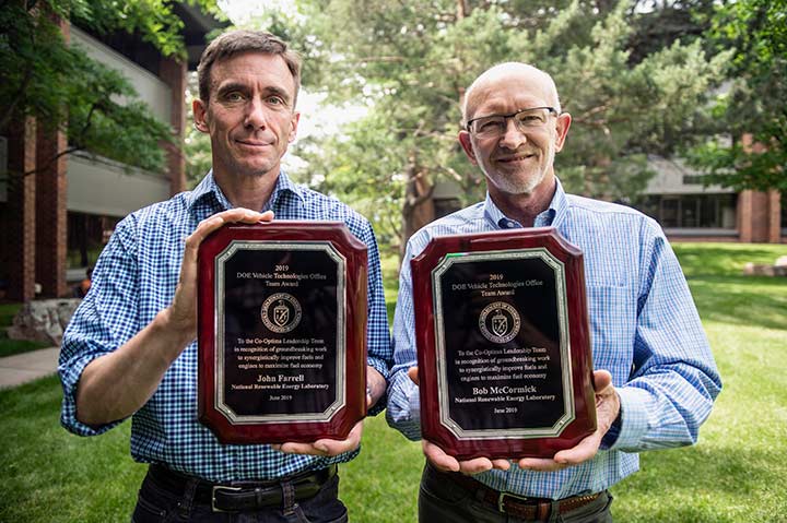 Researchers display their award plaques