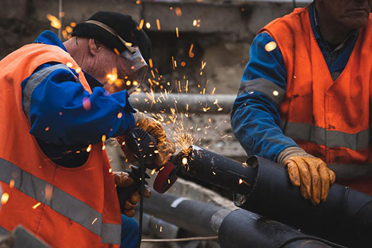 Workers repair damaged electrical equipment in Ukraine.