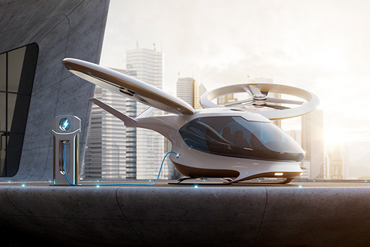 A digital rendering of an electric aircraft attached to a charger, with high-rise buildings in the background.