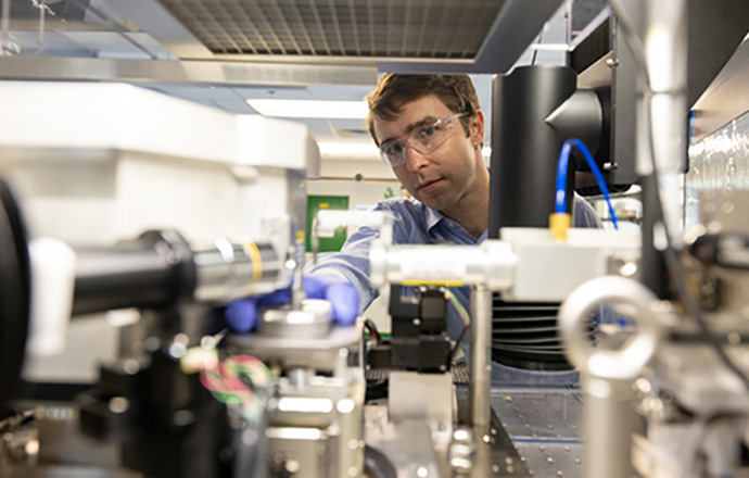 A researcher working with a machine.