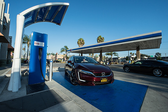 A car fueling at a hydrogen fueling station.