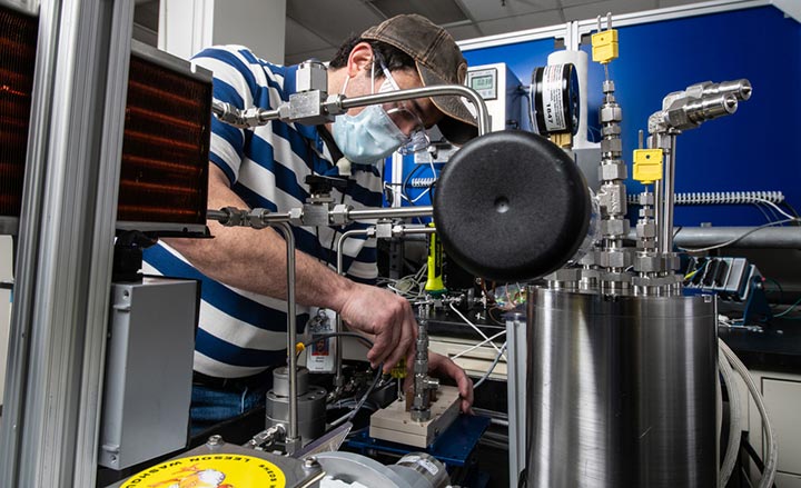 A photo of a researcher using a dielectric fluid loop