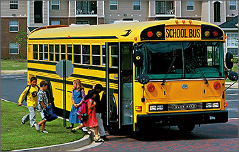Photo of children boarding school bus.