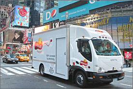 Photo of medium-duty truck with "100% powered by electricity" printed on its side.
