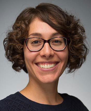 This is a photo of a woman smiling with glasses on