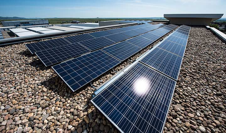 A solar panel system situated on the roof of a building on a sunny day