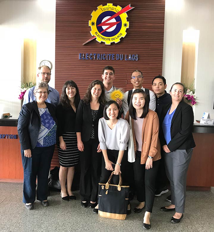 Group photo of 10 people in front of the Electricite Du Laos reception desk