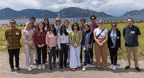 Interns from the Women in Power System Transformation program stand outside for photo
