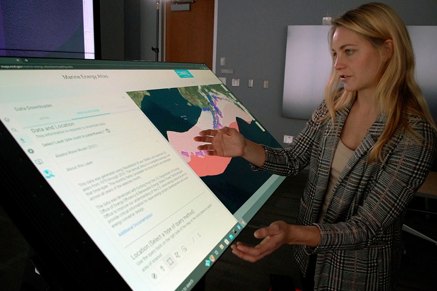 Person uses marine energy atlas on large computer display.