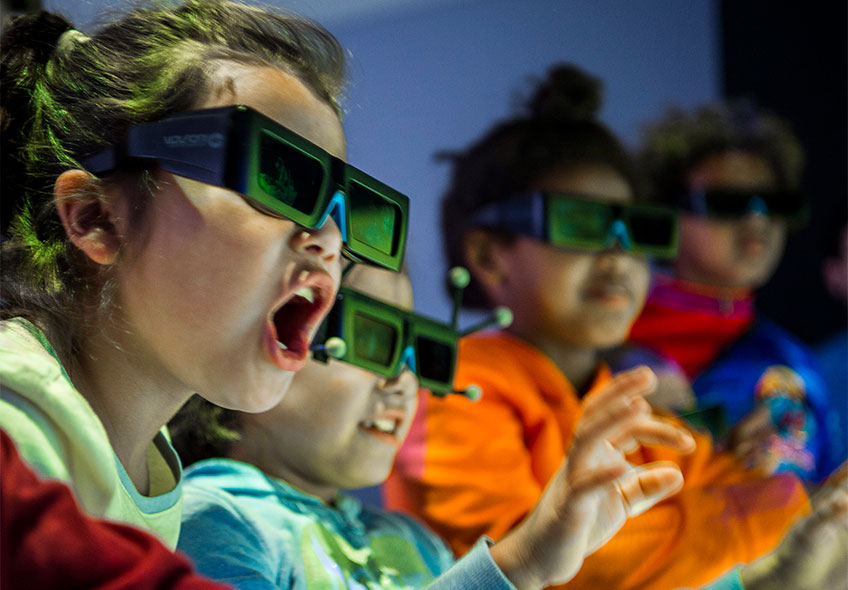Photo of a group of children wearing 3-D visualization glasses.