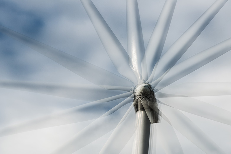 A close-up of a wind turbine as its spinning.