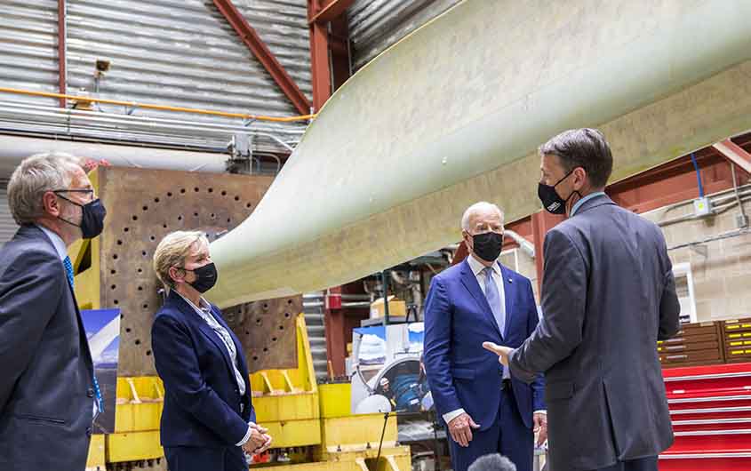 President Biden, Jennifer Granholm, Martin Keller, and Daniel Laird view a wind turbine blade.
