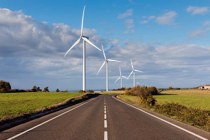 Wind turbines along a road.
