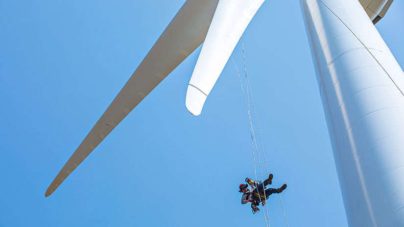 Person repelling down a wind turbine
