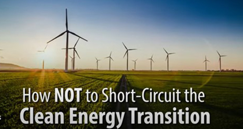 Wind turbines in a field overlain with bold text: “How NOT to Short-Circuit the Clean Energy Transition.”