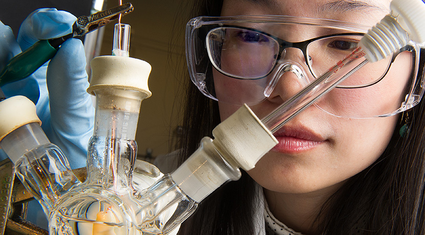 Photo of a woman in safety glasses using a photo electrode, consisting of three glass tubes, to split water.