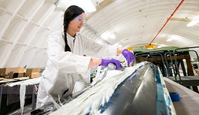 NREL researcher works on a thermoplastic composite turbine blade.