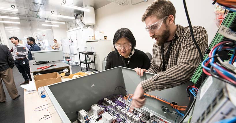 Eaton Strategic Partners work on a hardware prototype in their lab at the ESIF.