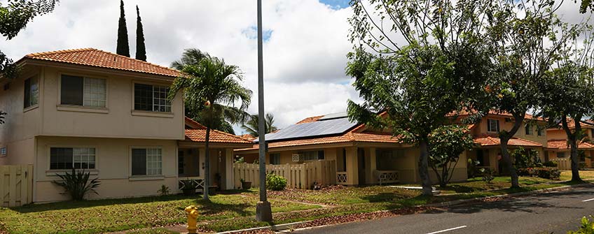 Photo of a home with a rooftop solar system in a residential neighborhood in Hawaii.