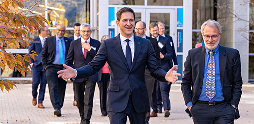 partners-72799 A group of people walking with one in front smiling