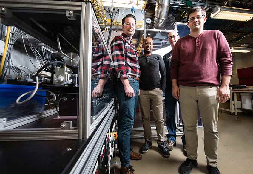 Four researchers in the lab at NREL.