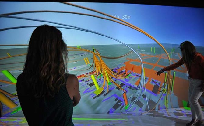 Two researchers evaluate a 3D visualization of an energy system