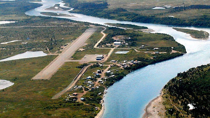 An aerial view of a river the small village of Iguigig, Alaska on the river bank