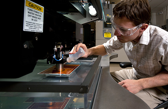 A researcher working in a laboratory with equipment.