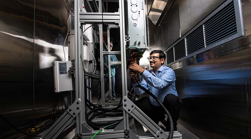 A researcher conducting energy storage research at NREL's Energy Systems Integration Facility.